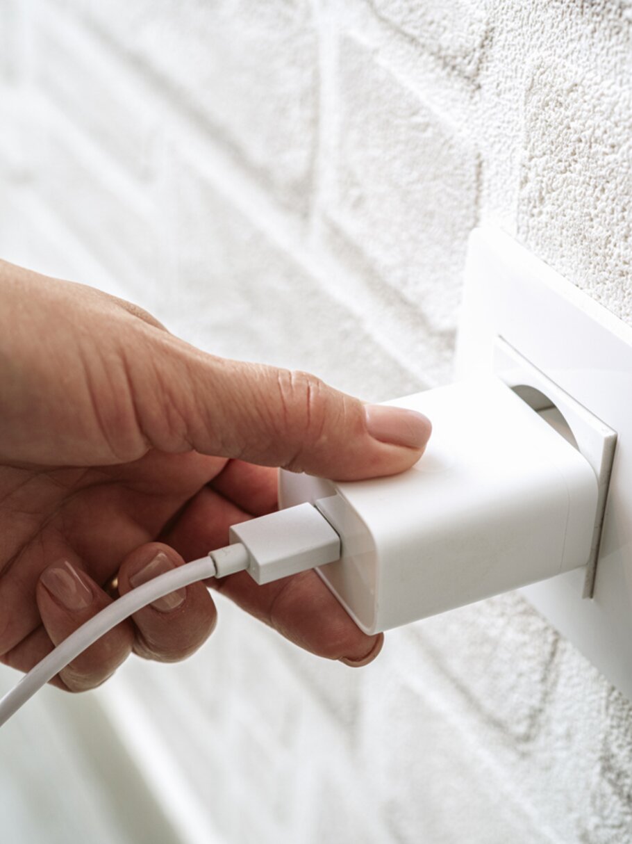 Ladekabel an Steckdose – Symbol für alltägliche Energieanwendung.